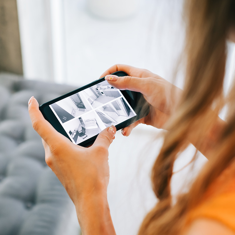 oman monitoring security cameras on smartphone indoors