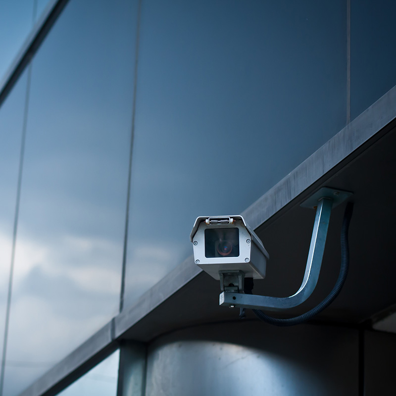 A security camera on the exterior of a building.